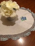 HANDMADE WHITE OVAL LINEN DOILY WITH BLUE CROCHET EDGINGS AND FLOWERS ,22 X 16 INS