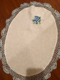 HANDMADE WHITE OVAL LINEN DOILY WITH BLUE CROCHET EDGINGS AND FLOWERS ,22 X 16 INS